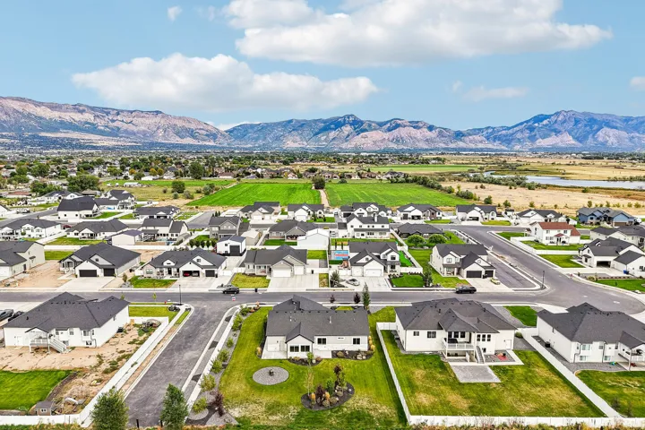 Expansive neighborhood featuring residential homes, manicured lawns, and paved streets