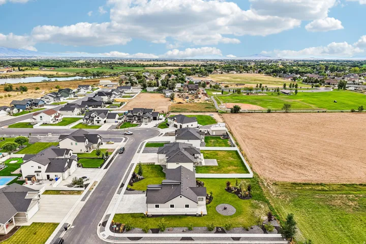 New construction residential development with established landscaping, paved streets, and concrete sidewalks