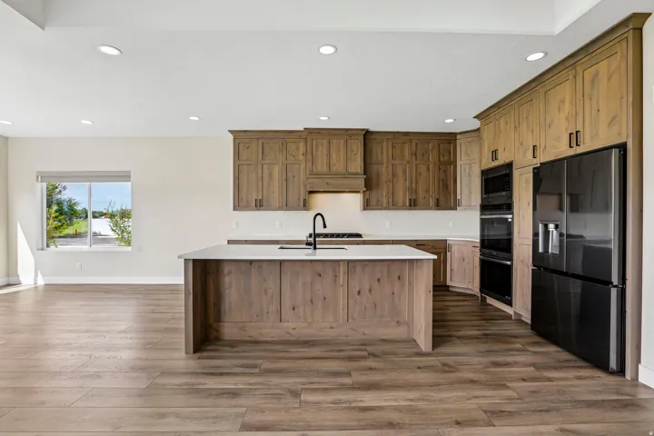 Wood-finish flooring throughout, complemented by light-toned walls and a recessed lighting system