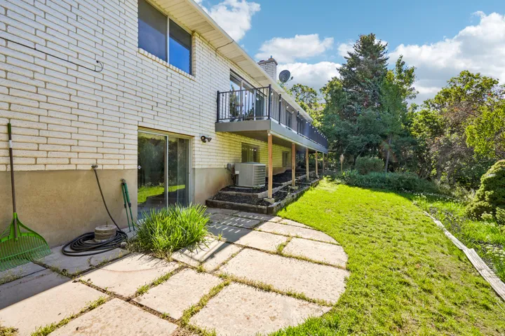 White brick exterior with a lower-level concrete patio