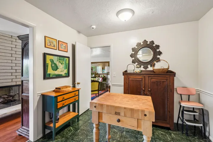Green marble-finish tile flooring with white walls and trim