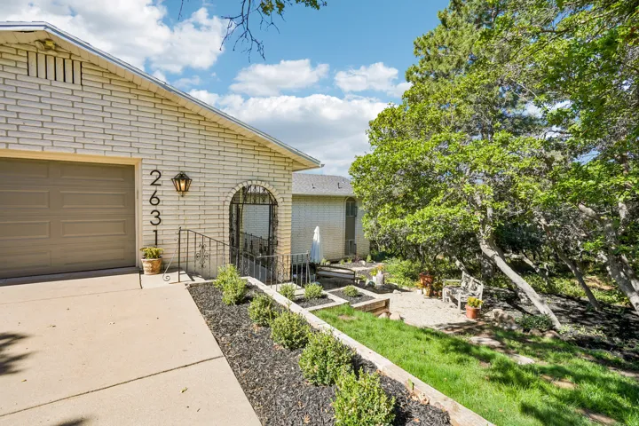 Brick exterior with an arched entry and wrought iron railing