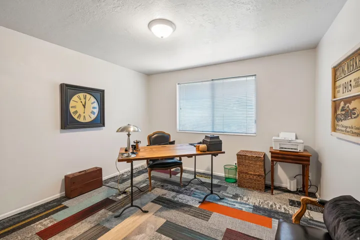 Recessed window with blinds, overhead flush mount light fixture, and light-colored wall paint