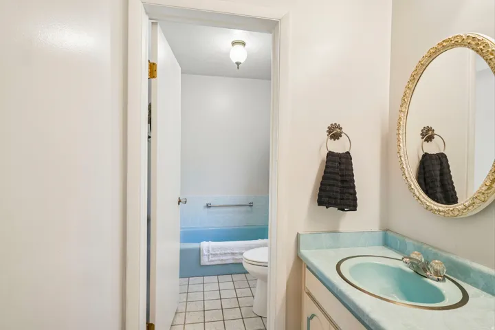 Vanity with an integrated basin and dual-handle faucet