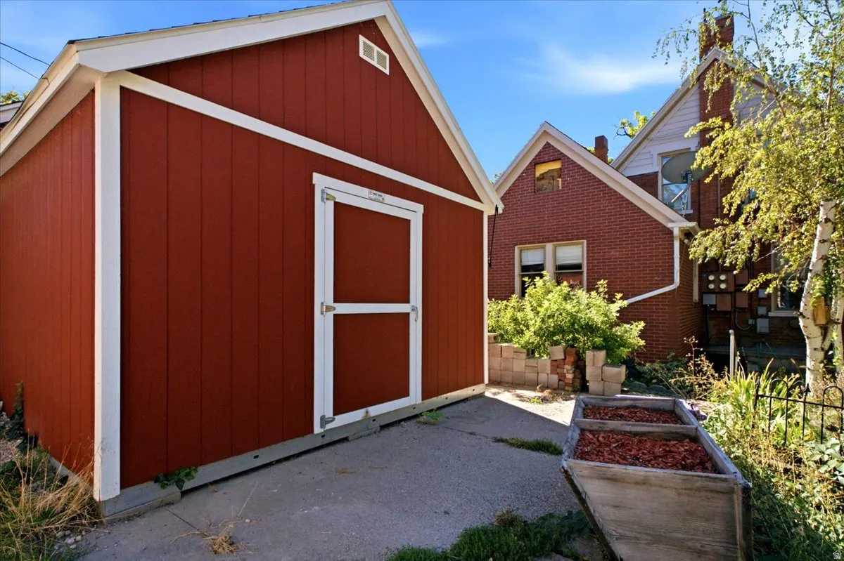 Storage shed with vertical siding and white trim