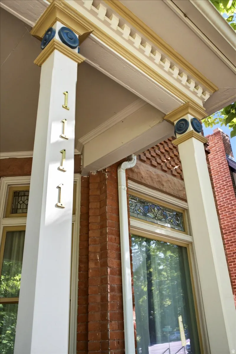 Ornate column details, brick exterior, and decorative stained-glass window accents