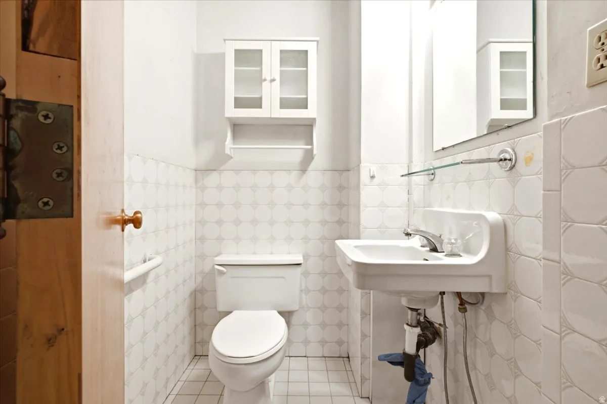 White ceramic wall-mounted sink with chrome faucet