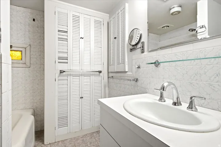 White vanity with an integrated sink and chrome faucet