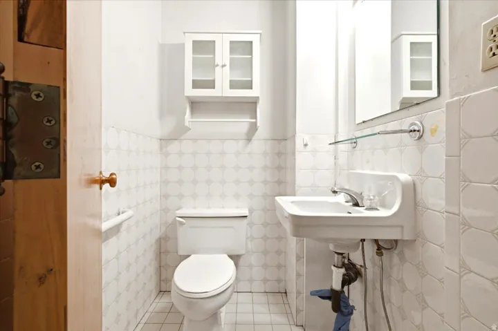 White ceramic wall-mounted sink with chrome faucet