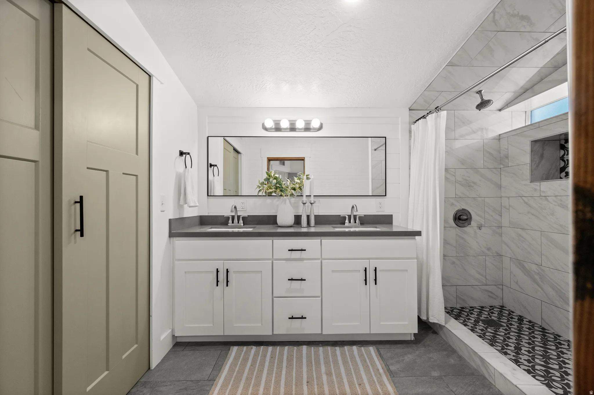 Dual vanity with undermount sinks and dark countertops