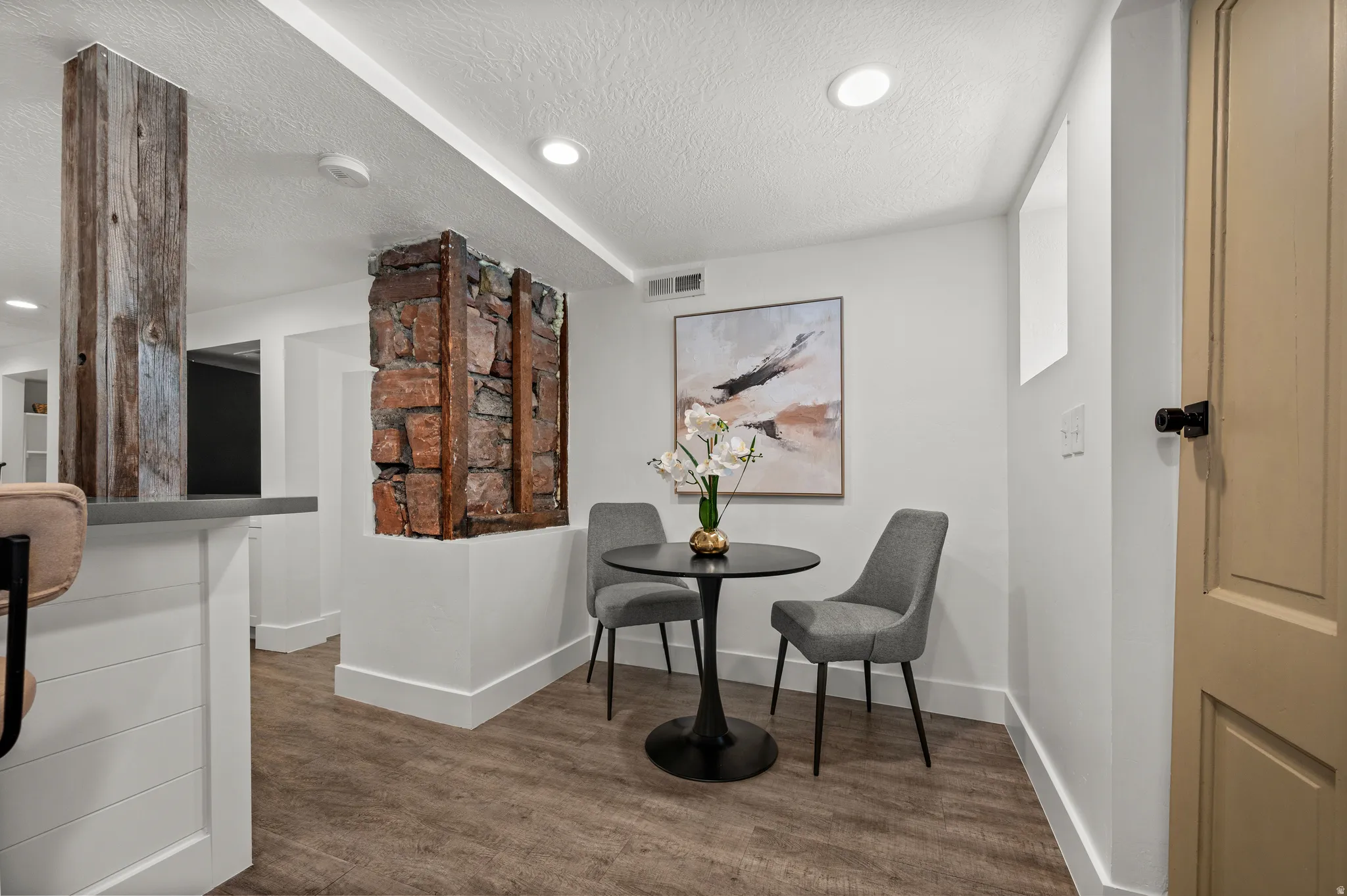 Wood-finish flooring with white baseboards throughout
