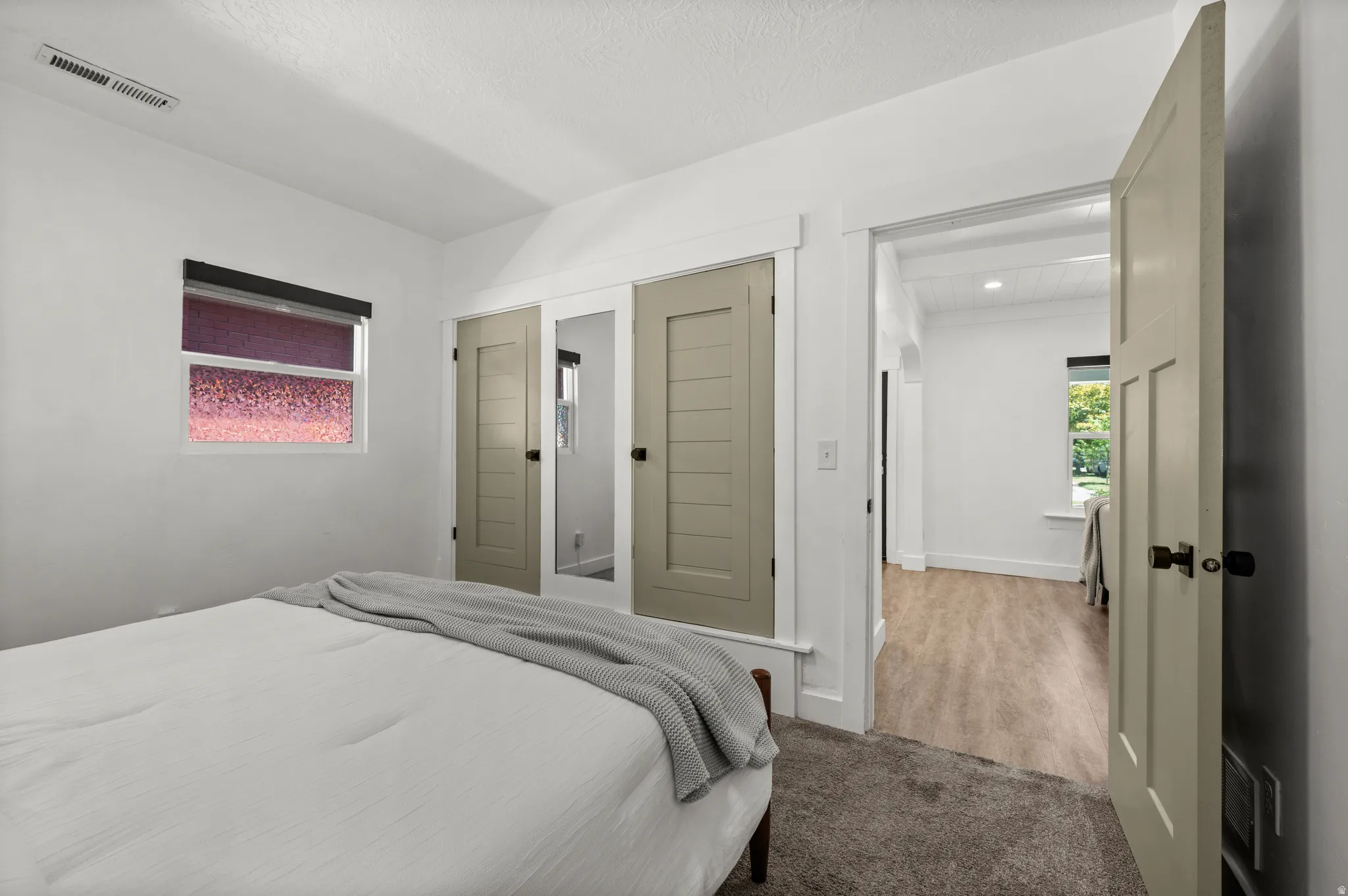 White walls, neutral-toned trim, and wood-finish flooring