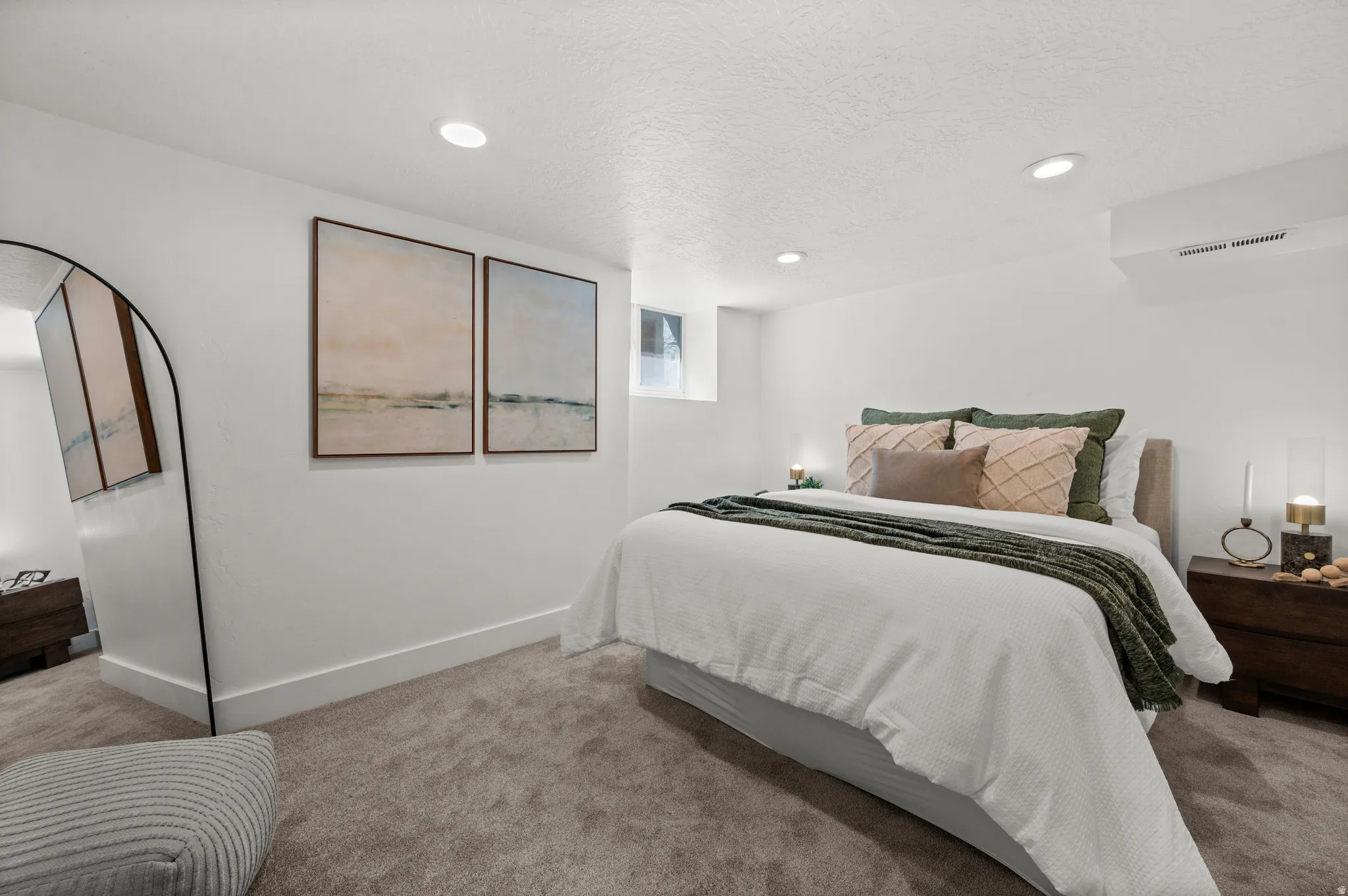 Recessed lighting, light gray carpet, white walls, and a window