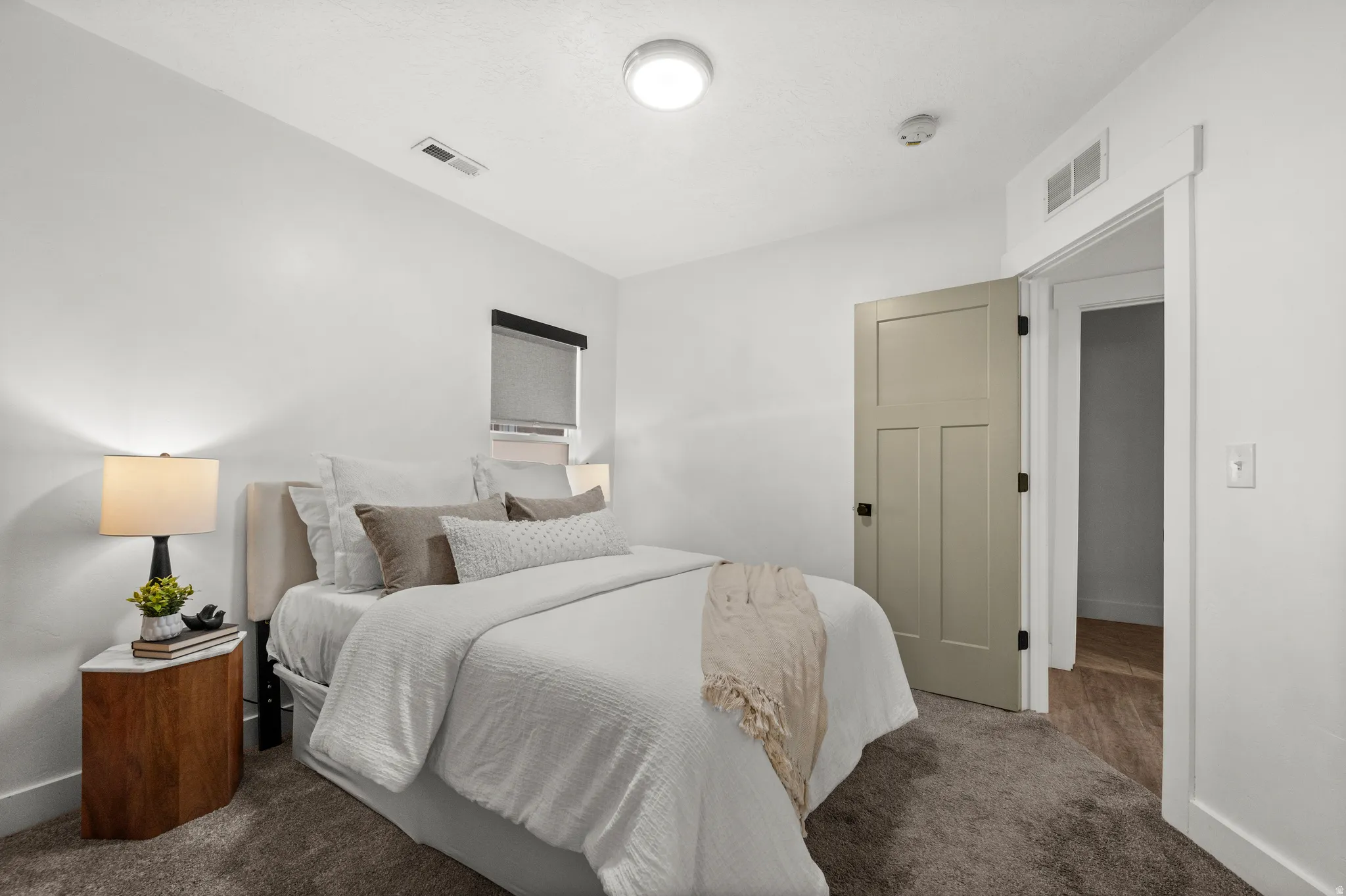 Recessed lighting, wood-finish flooring, and a paneled interior door