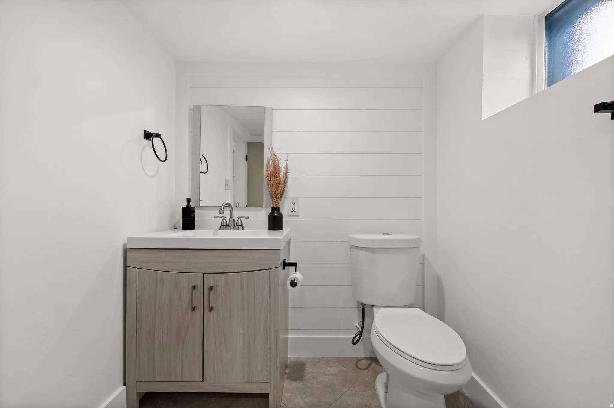 Vanity with a basin sink, chrome faucet, and integrated countertop