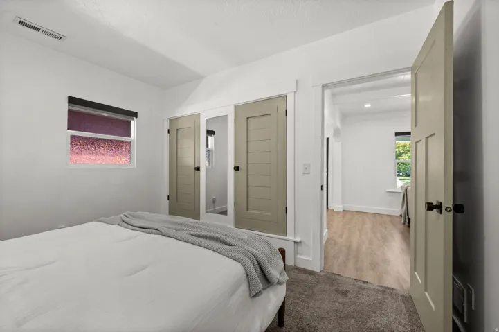 White walls, neutral-toned trim, and wood-finish flooring