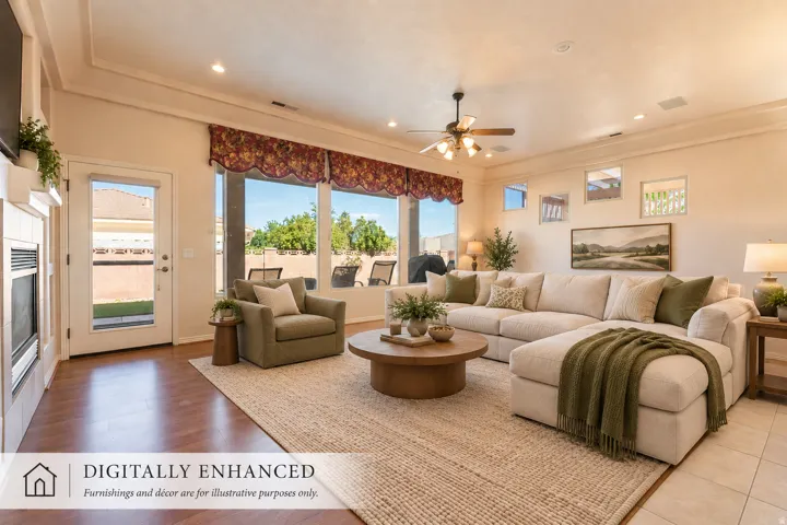 Wood-finish flooring, recessed lighting, ceiling fan, multiple windows, and a glass-paneled exterior door