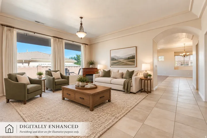 Expansive living area with large windows, recessed lighting, crown molding, and an arched entryway