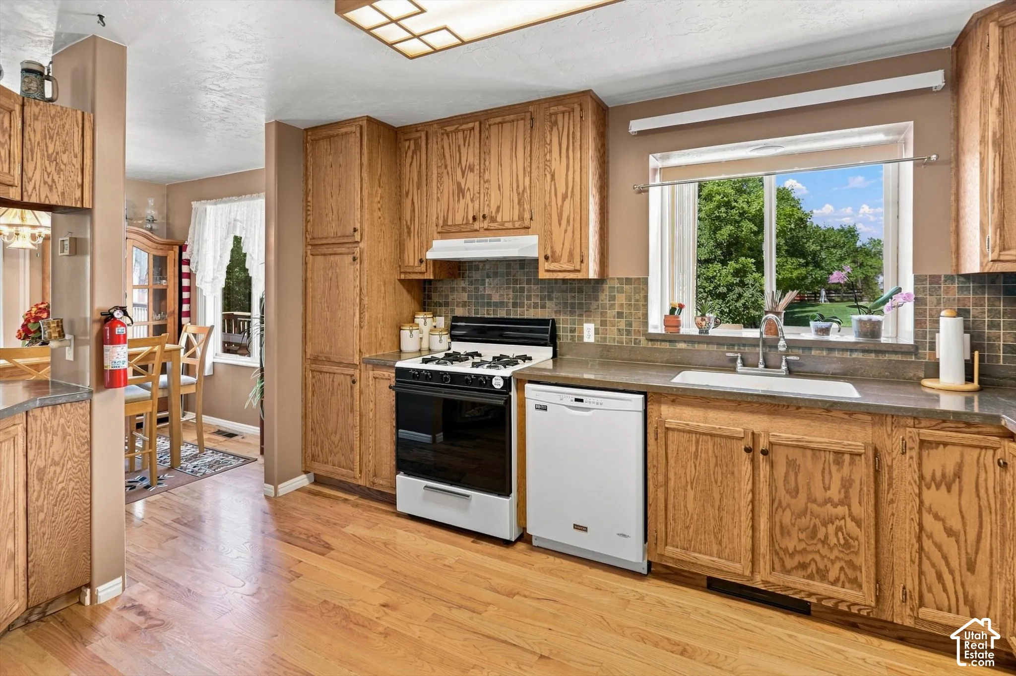Hardwood flooring, wood cabinetry, built-in dishwasher, gas range, and great natural lighting.