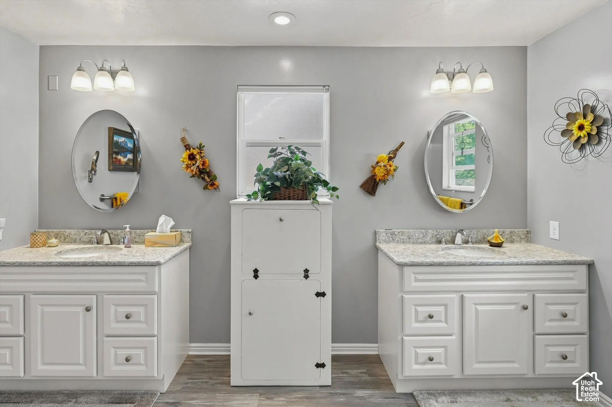 Dual vanities with undermount sinks and light-toned countertops