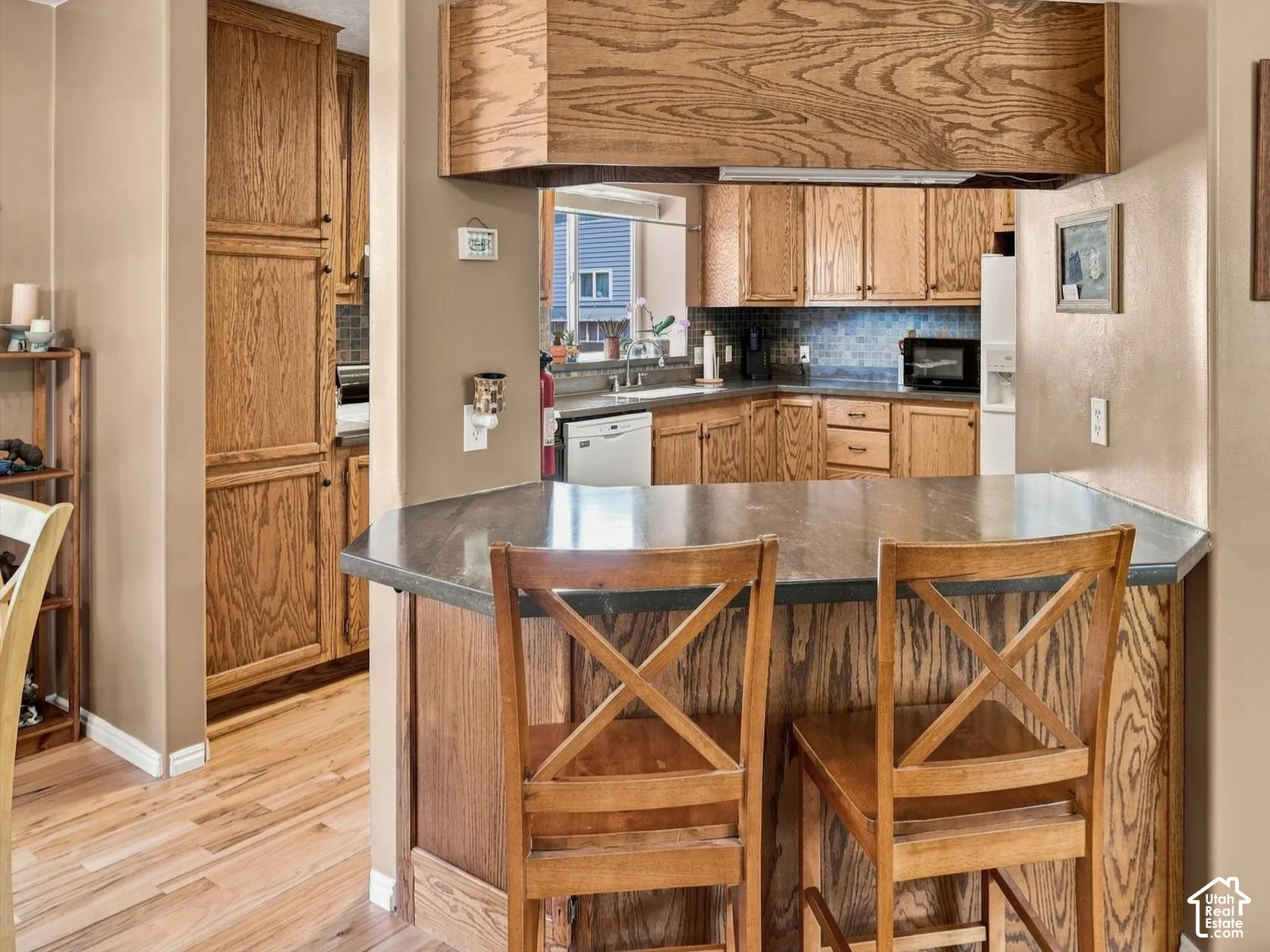 Kitchen bar with plenty of cabinet space above and below.