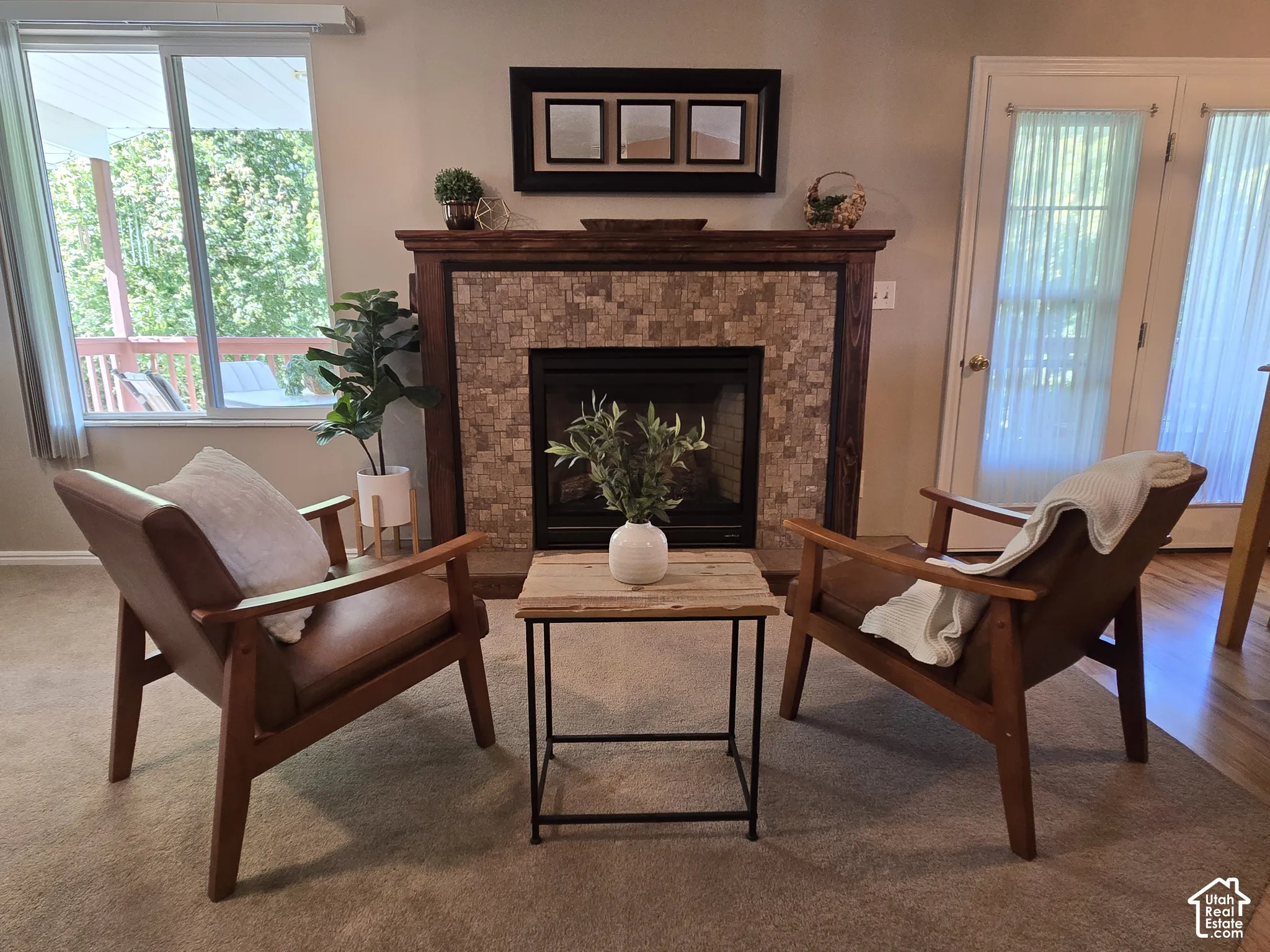 Fireplace featuring a natural stone tile surround and wood mantel.