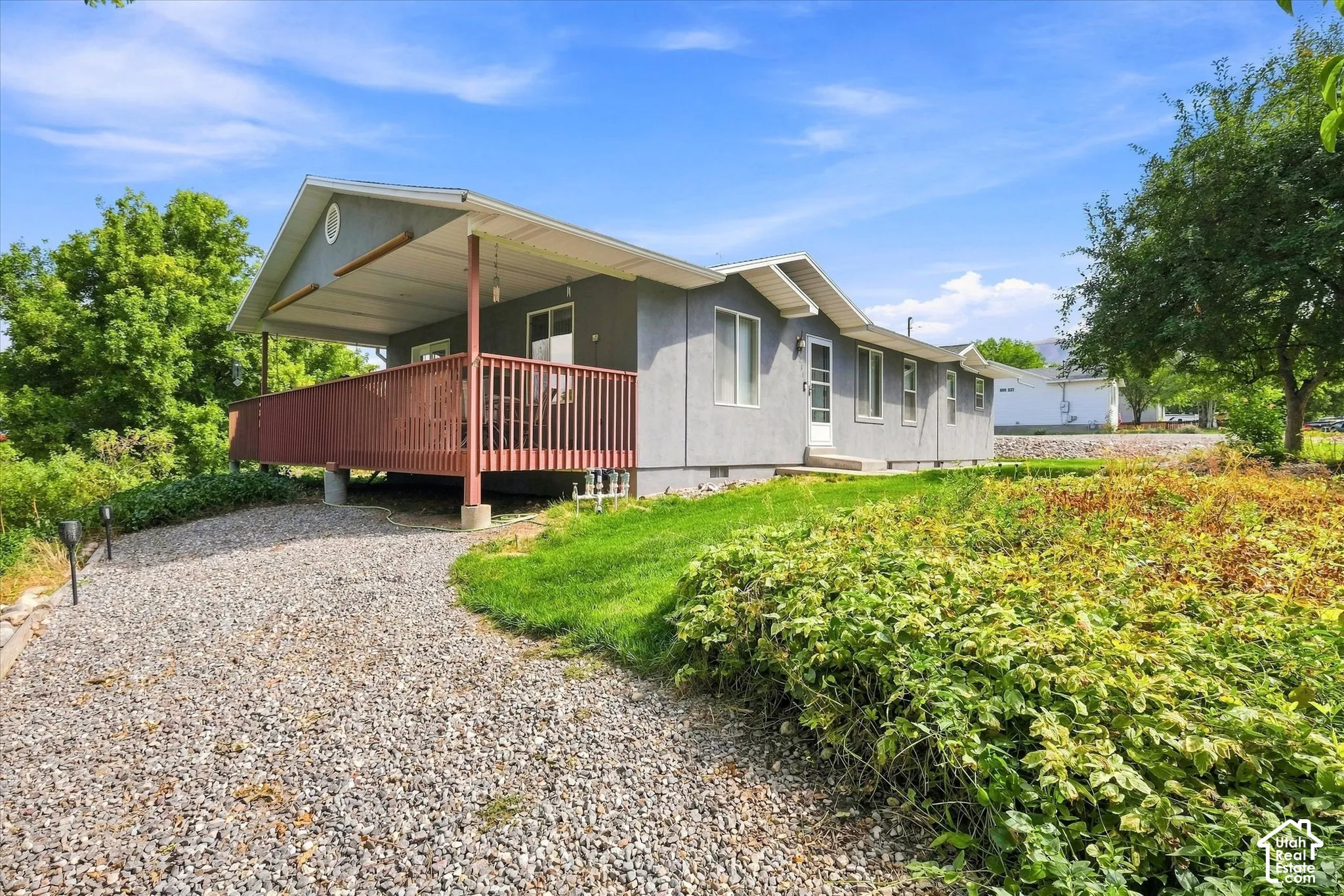 Covered outdoor west deck, gravel, and ground cover
