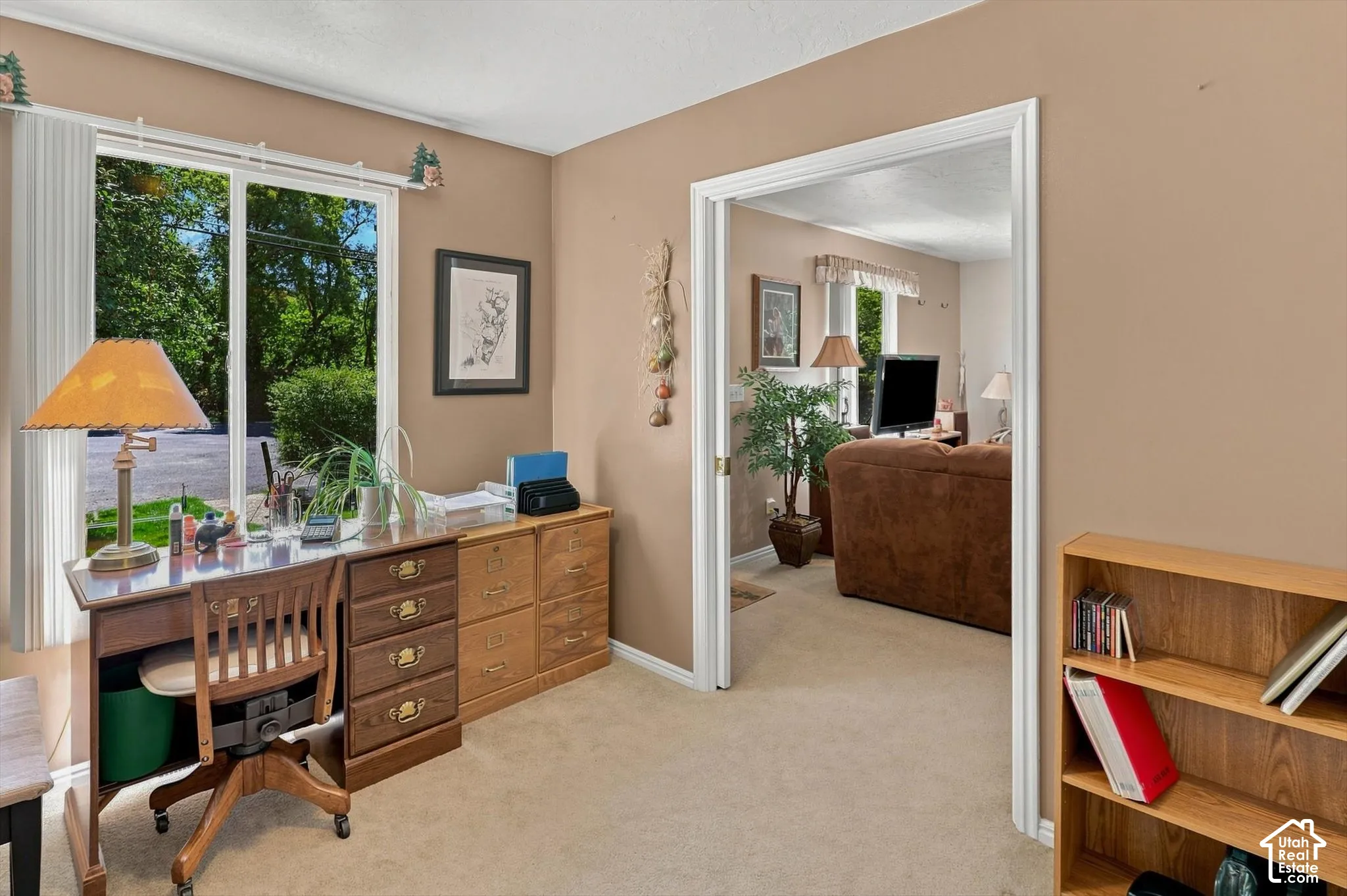 Office or third bedroom with a large window and a pocket door leading into the living room