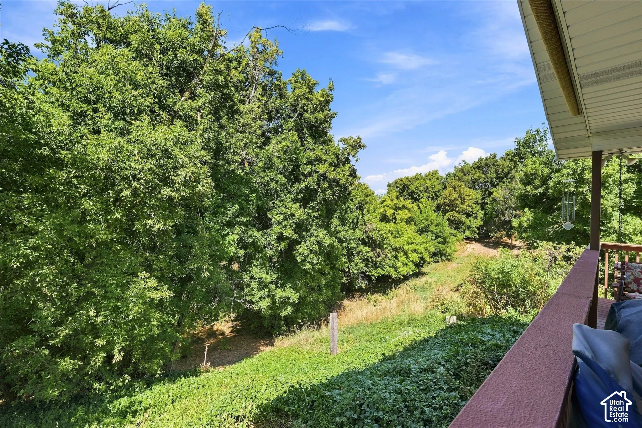 Expansive outdoor deck with wood railing, offering a fabulous private oasis