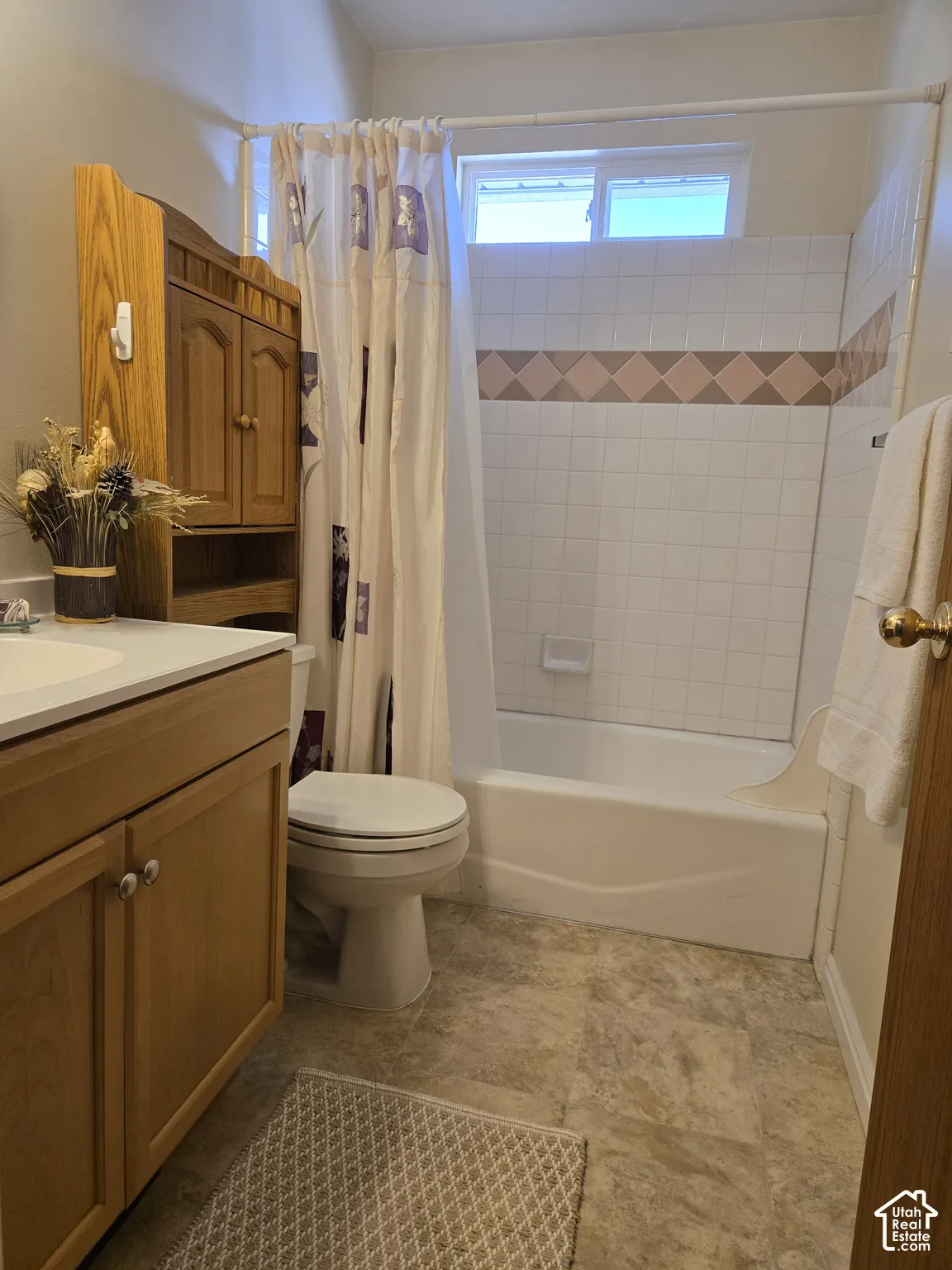 Second bathroom with vanity and bath-shower combo