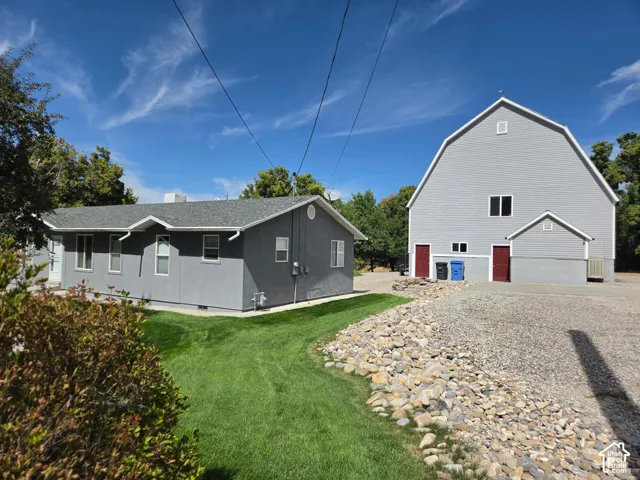 Two-story structure with a gambrel roof and a single-story building with a gabled roof