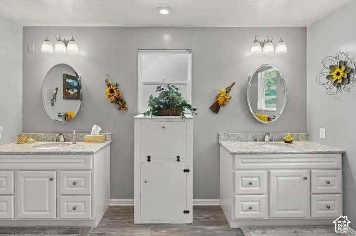 Dual vanities with undermount sinks and light-toned countertops