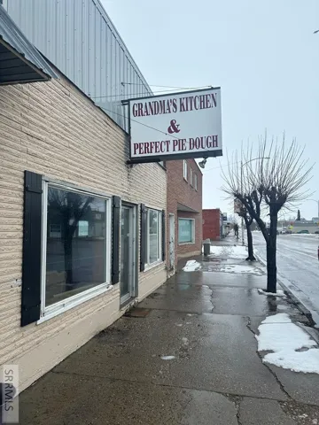 Commercial storefront with a prominent exterior sign and brick-textured siding