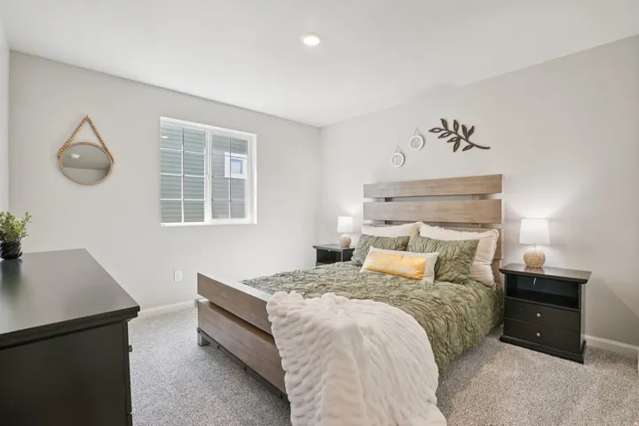 Recessed lighting, light gray wall color, white window frame, and gray carpeting