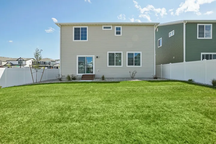 Expansive green lawn with a full privacy fence