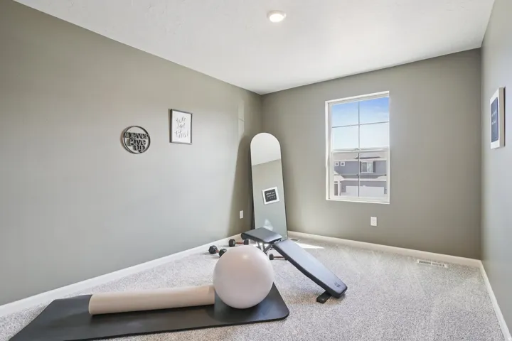 Recessed ceiling lighting, light gray walls, white trim, and a window with white framing