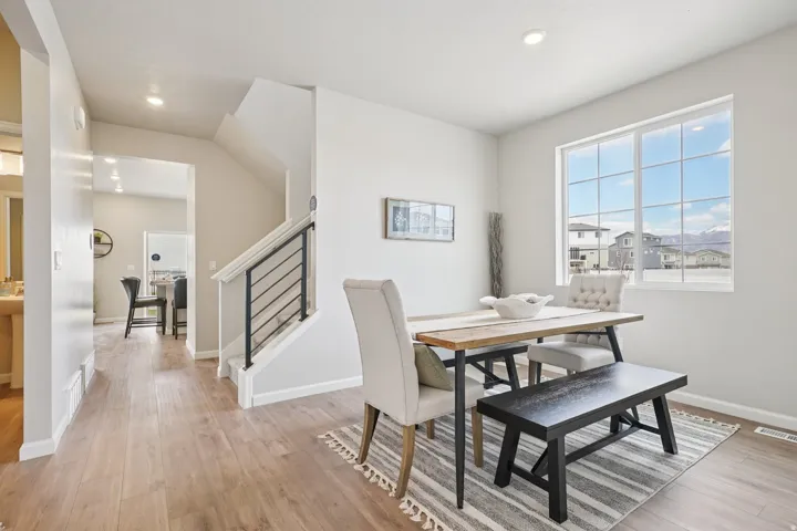 Spacious dining area with wood-finish flooring