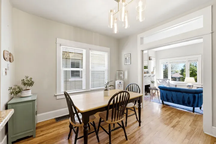 Hardwood flooring, white window blinds, recessed lighting, and a wide cased opening