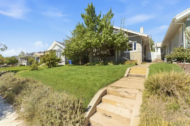 Front yard with tiered concrete pathway and mature landscaping