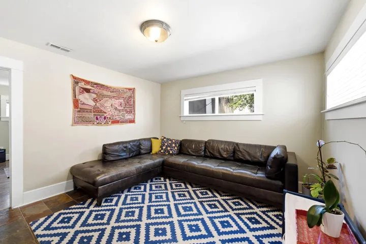 Light-toned walls with multiple windows and a semi-flush mount ceiling fixture