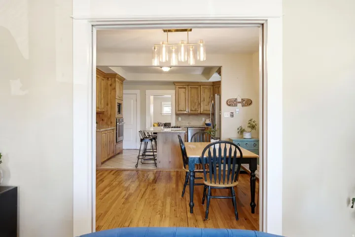 Wood-finish flooring throughout, with a tiled kitchen area