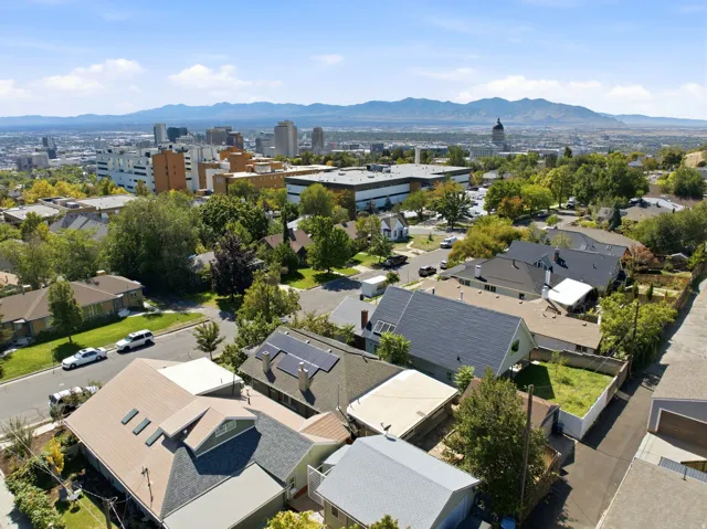 Residential street with a distant city skyline and mountainous backdrop