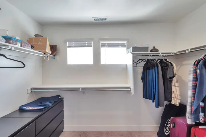 Built-in shelving, integrated hanging rods, and twin windows