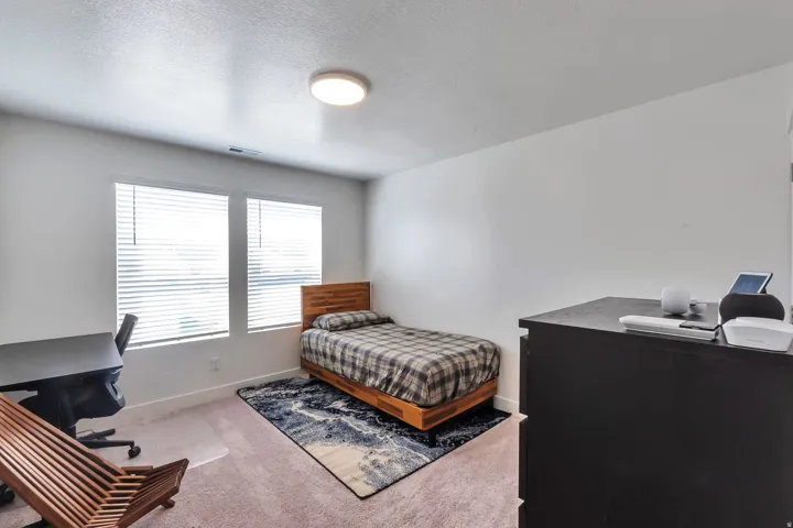 Two windows with blinds, recessed lighting, and light-toned wall finishes
