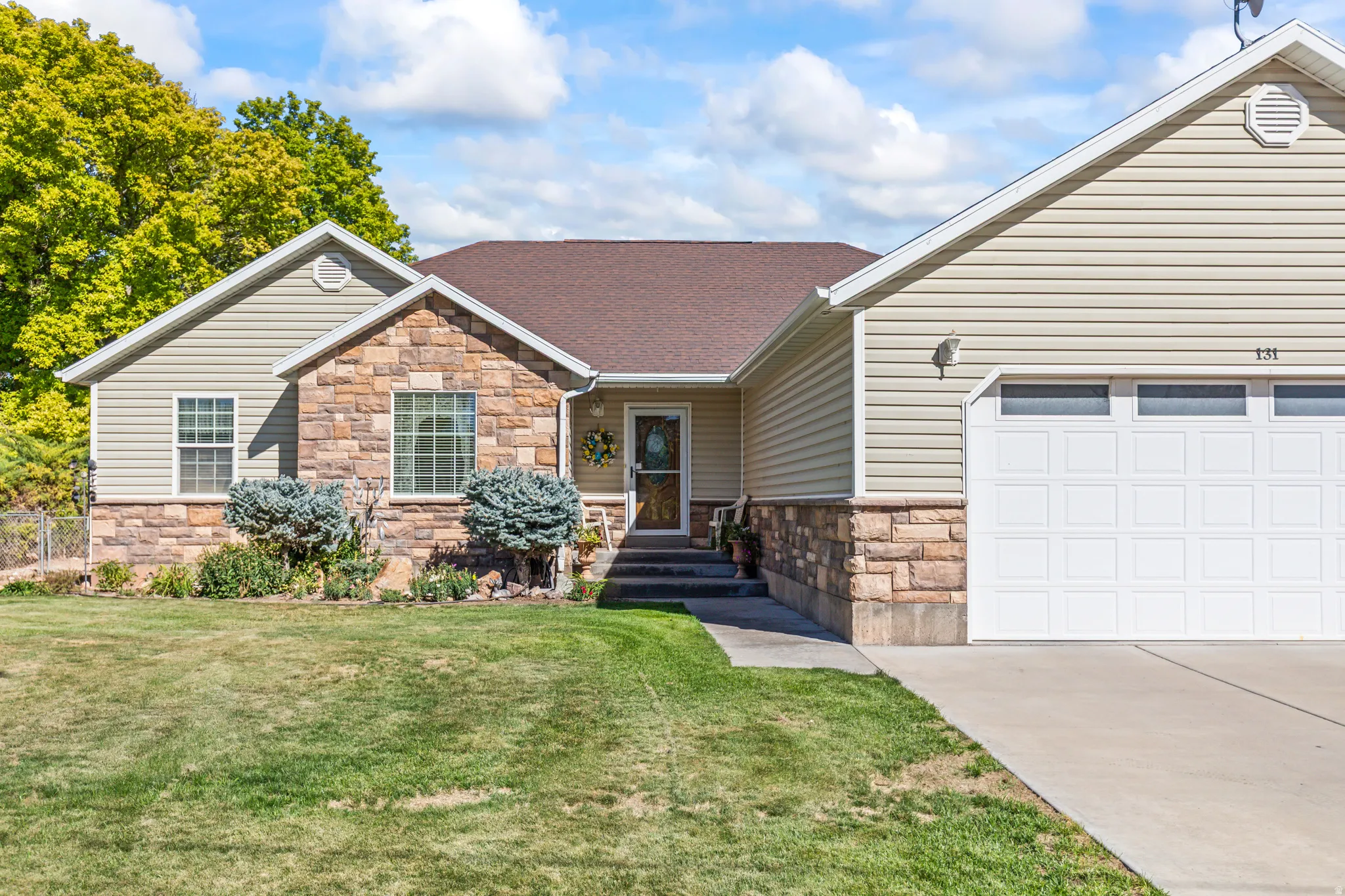 Exterior featuring stone and siding finishes