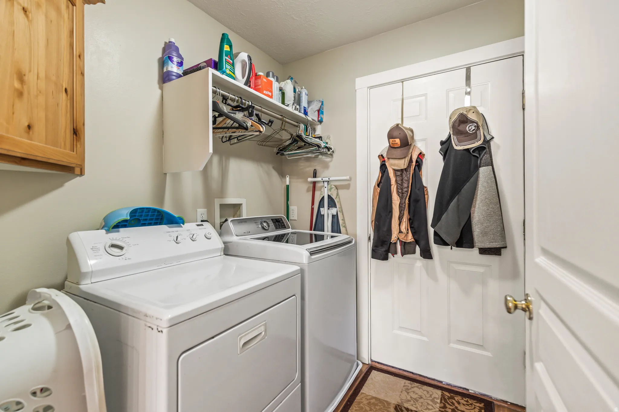 Built-in upper cabinetry, white shelving, and dual-door entry