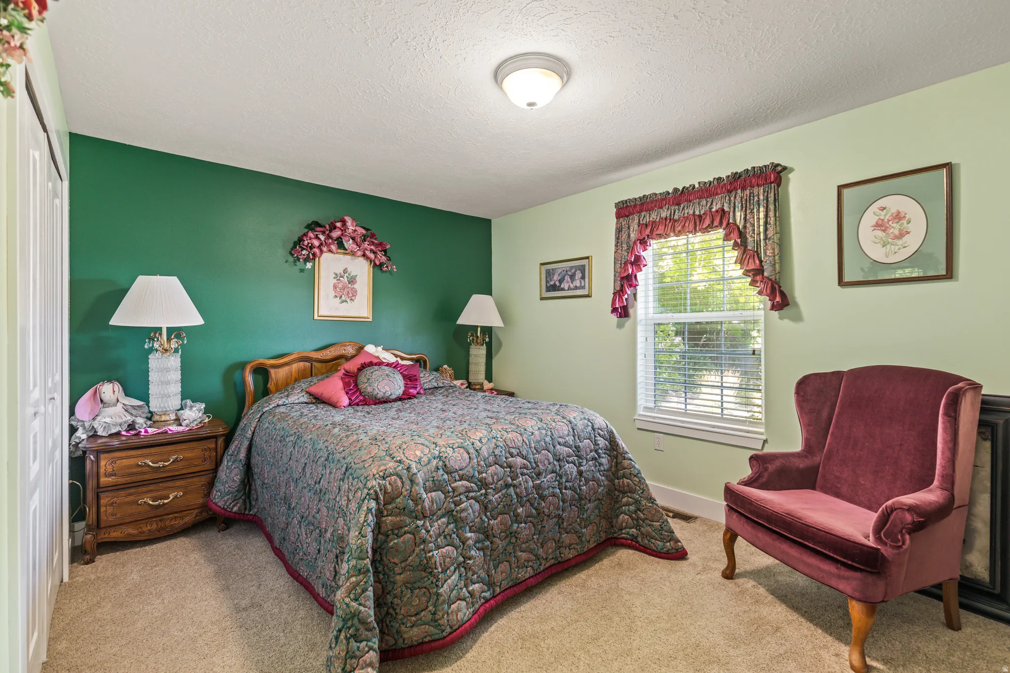 Carpeted flooring, a window with horizontal blinds, and a built-in closet with bi-fold doors