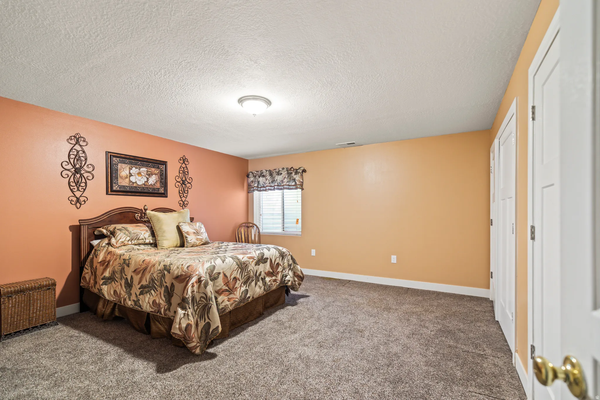 Carpeted flooring, recessed window with blinds, and white trim