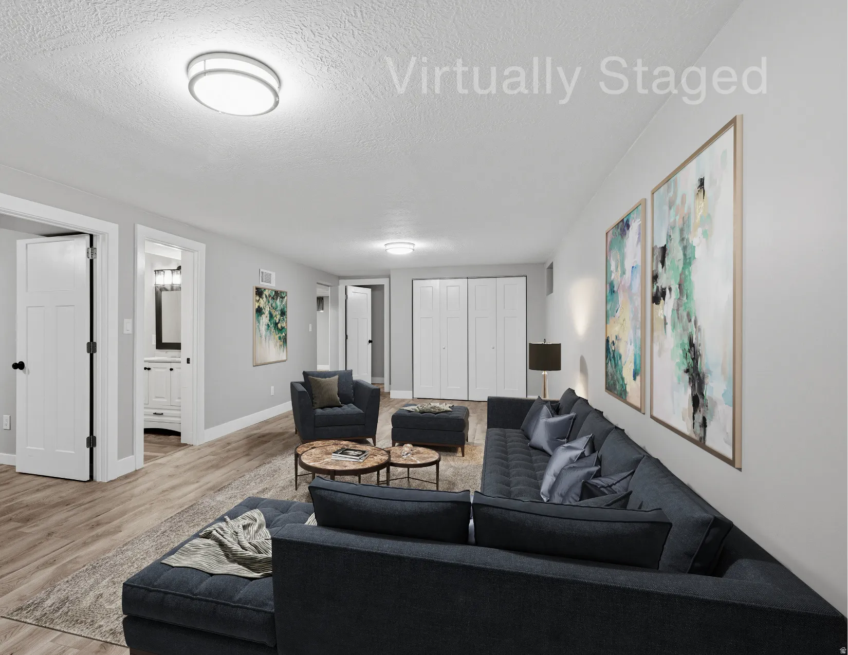 Lower level gathering space with fireplace, laminate flooring, fresh neutral paint and LED lighting.  Virtually staged.