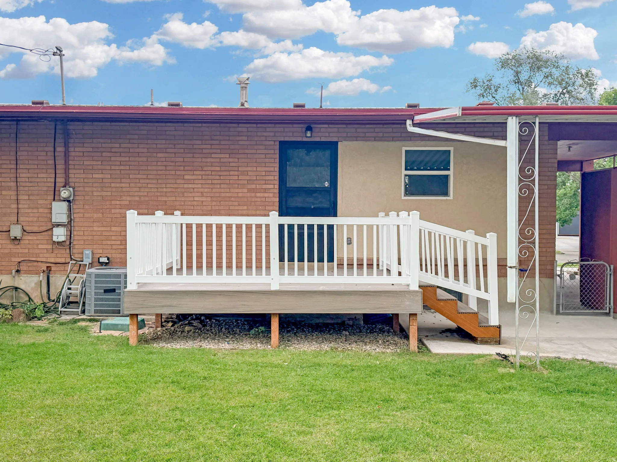 Brand new deck features vinyl railings and engineered wood surface